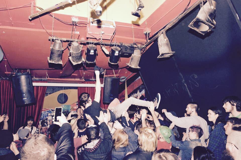 Crowd surfer lifted above the room